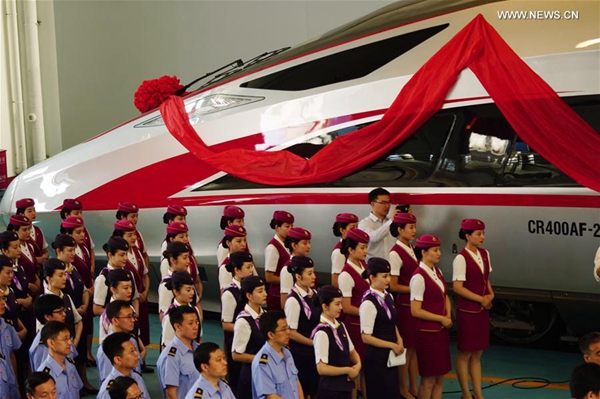 People attend a naming ceremony for the new models of China's electric multiple unit (EMU) train 'Fuxing' in Beijing, capital of China, June 25, 2017. China holds complete intellectual property rights of 'Fuxing' high speed trains. Two new 'Fuxing' trains will debut on Beijing-Shanghai high speed railway line on June 26, 2017 in Beijing and Shanghai at the same time. [Photo/Xinhua]