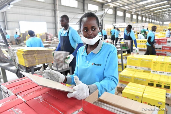 A worker checks ceramic tiles at Twyford Ceramics in Kajiado County, Kenya, May 12, 2017. Twyford Ceramics which happens to be a leading manufacturer of high end tiles has offered a new lease of life to Kenyan youth who often endure agony of joblessness after finishing college. [Photo/Xinhua]