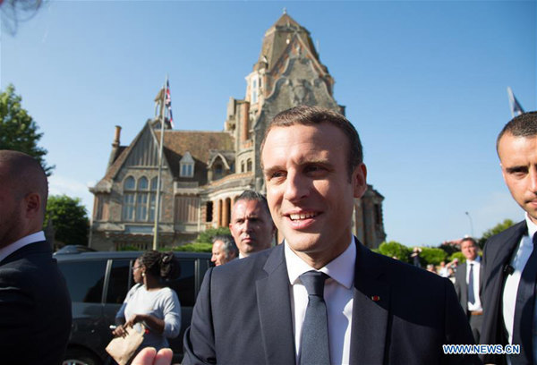 French President Emmanuel Macron greets his supporters after he voted at the city hall in the second round of the parliamentary elections in Le Touquet, France on June 18, 2017. (Xinhua/Kristina Afanasyeva)