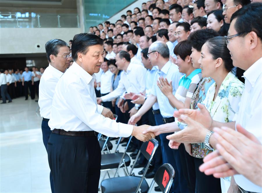 Liu Yunshan shakes hands with graduates of the 2017 spring semester before a graduation ceremony of the school in Beijing, capital of China, July 7, 2017. [Photo/Xinhua]