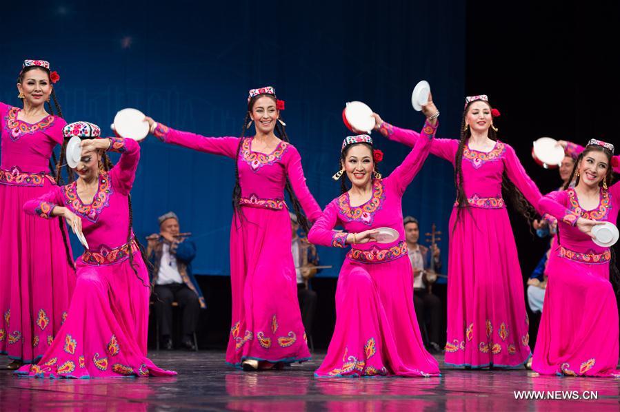 Artists from China's Xinjiang Uygur Autonomous Region dance in Alexandria, Egypt, on July 10, 2017. Xinjiang Uygur Autonomous Region, which represents China as the guest of honor of the 15th International Summer Festival held from July 10 to August 26 in Egypt's seaside historical city of Alexandria, gave an enchanting performance on Monday. [Photo/Xinhua]