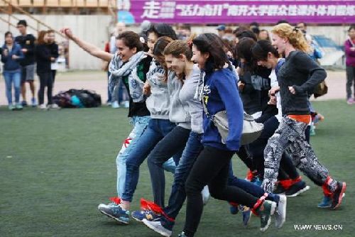 Students take part in a collective-running game at a Foreign Students Sports Meeting in NankaiUnversity in Tianjin. [Xinhua file photo]