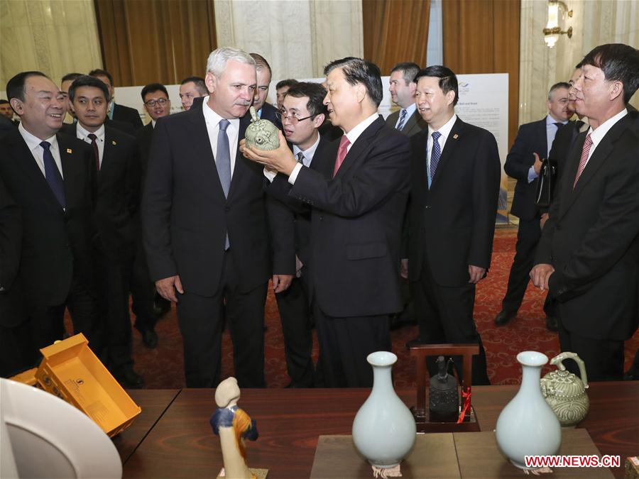 Liu Yunshan, a member of the Standing Committee of the Political Bureau of the Communist Party of China (CPC) Central Committee, and Liviu Dragnea, chairman of Romania&apos;s ruling Social Democratic Party (PSD) and speaker of the Chamber of Deputies, visit a promotion fair of Chinese local governments before the political parties dialogue between China and the Central and Eastern European (CEE) countries in Bucharest, Romania, July 14, 2017. [Photo/Xinhua]