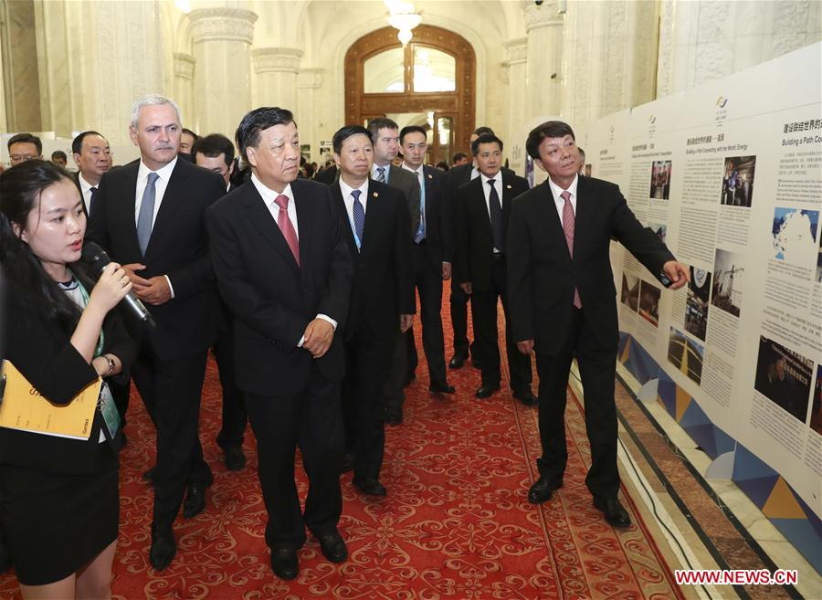 Liu Yunshan, a member of the Standing Committee of the Political Bureau of the Communist Party of China (CPC) Central Committee, and Liviu Dragnea, chairman of Romania&apos;s ruling Social Democratic Party (PSD) and speaker of the Chamber of Deputies, visit a photo exhibition displaying the Belt and Road Initiative achievements before the political parties dialogue between China and the Central and Eastern European (CEE) countries in Bucharest, Romania, July 14, 2017. [Photo/Xinhua]