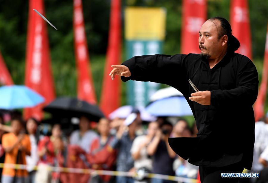 A contestant performs in the Flying Knife Kungfu category during a martial arts competition held in Shaolin Temple, central China&apos;s Henan province, July 30, 2017. The competition features four traditional events of Iron Palm Kungfu, Stone Lock Kungfu, Two-Finger Zen and Flying Knife Kungfu. (Xinhua/Li An)