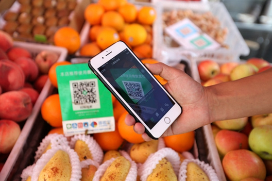 Alipay and WeChat Pay lead China's move to a cashless society, so customers can scan for purchases. [Photo/China Daily]