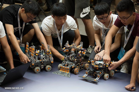 Contestants debug robots during the World Robot Conference 2017 in Beijing, capital of China, Aug. 23, 2017.