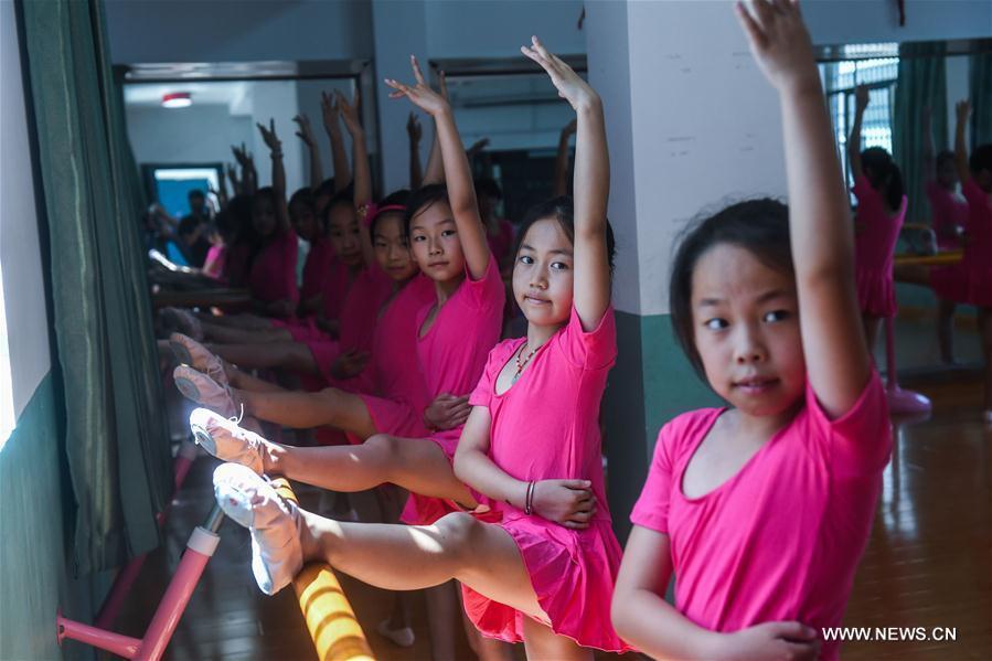 Dance troupe members, in new cloths and shoes, practice in the Red Army Primary School in Liangnong Town of Yuyao City, east China's Zhejiang Province, Sept. 1, 2017. 