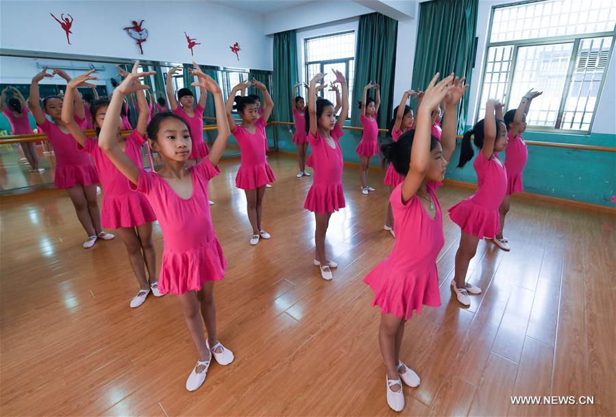 Dance troupe members, in new cloths and shoes, practice in the Red Army Primary School in Liangnong Town of Yuyao City, east China's Zhejiang Province, Sept. 1, 2017. 