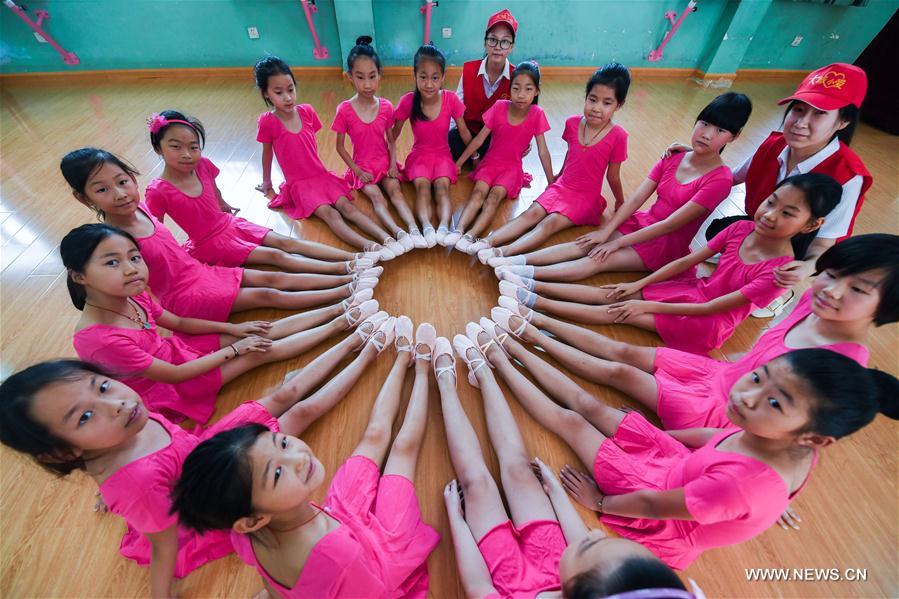 Dance troupe members show their new cloths and shoes in the Red Army Primary School in Liangnong Town of Yuyao City, east China's Zhejiang Province, Sept. 1, 2017.