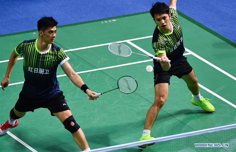 Fu Haifeng (L) and Zhang Zhijun of Guangdong compete during the men&apos;s team of badminton Group E match against Tianjin at the 13th Chinese National Games in north China&apos;s Tianjin Municipality, Sept. 1, 2017. Guangdong won the match by 3-1. (Xinhua/Xu Chang)