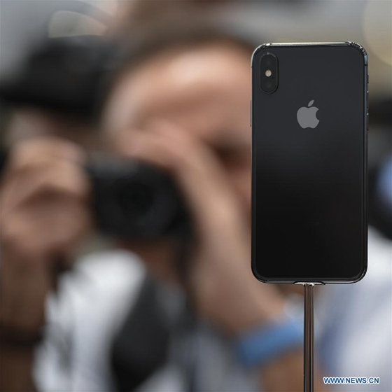 A man takes photos of new iPhone X displayed during a special event in Cupertino, California, the United States on Sept. 12, 2017. Apple Inc. released a series of new products and services in Cupertino on Tuesday. [Photo/Xinhua]