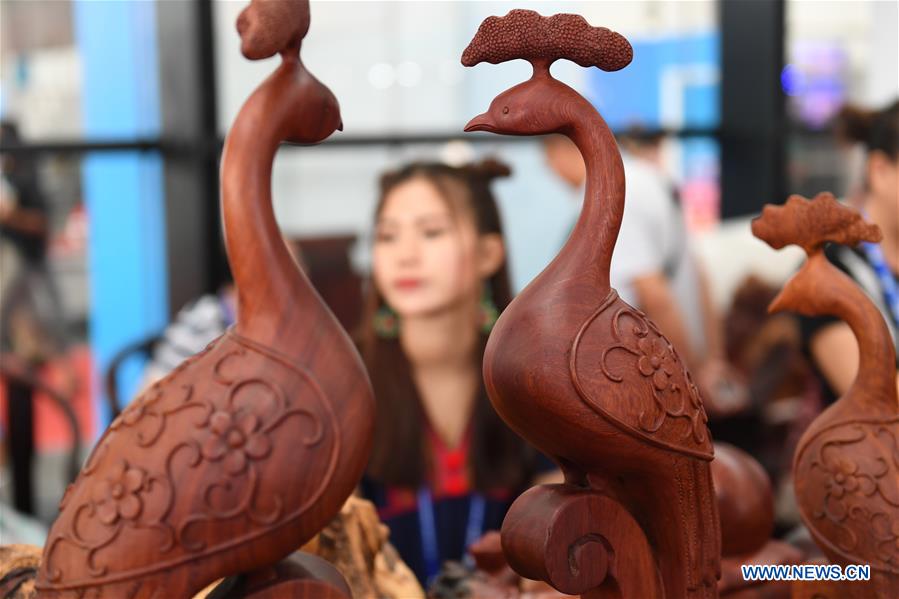 Photo taken on Sept. 13, 2017 shows carved wooden peacocks at the Laos pavilion during the 14th China-ASEAN Expo in Nanning, capital of south China&apos;s Guangxi Zhuang Autonomous Region. The 14th China-ASEAN Expo opened here Tuesday, highlighting trade and investment among China, ASEAN and other countries along the Belt and Road.(Xinhua/Zhou Hua)