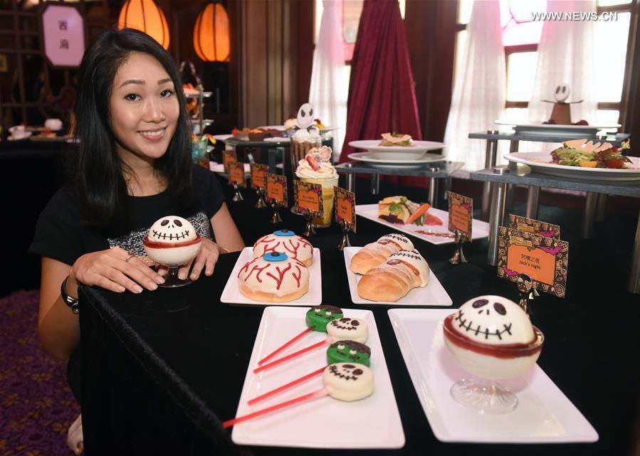 A model shows Halloween-themed food during a press preview at the Hong Kong Disneyland in Hong Kong, south China, Sept. 13, 2017. The Hong Kong Disneyland will host Halloween party from Sept. 14 to Oct. 31. (Xinhua/Liu Yun) 