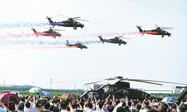 The Fenglei aerobatics team of the PLA Ground Force performs at the fourth China Helicopter Expo opening ceremony on Thursday in Tianjin. More than 400 helicopters from 22 countries and regions are on display at the expo.