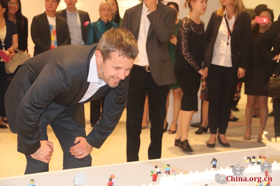  Danish Crown Prince Frederik appreciates a model of the Forbidden City built with LEGO bricks at an exhibition featuring the theme of “A Royal Modern Household” at the Danish Cultural Center in Beijing’s 798 Art District, Sept. 23, 2017. [Photo by Zhang Liying/ China.org.cn]