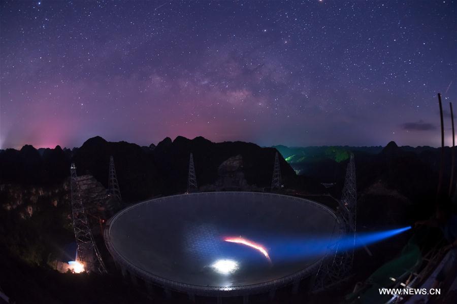 Photo taken on June 27, 2016 shows the Five-hundred-meter Aperture Spherical Telescope (FAST) under the stars in Pingtang county, Southwest China's Guizhou province. The China-based FAST, the world's largest single-dish radio telescope, has identified two pulsars after one year of trial operation, the National Astronomical Observatories of China (NAOC) said on Oct 10, 2017. [Photo/Xinhua] 