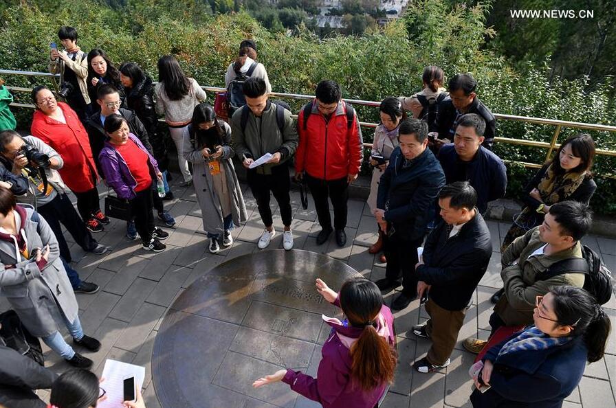 Journalists visit the Central Point of Beijing City in Jingshan Park in Beijing, capital of China, Oct. 12, 2017. The Press Center of the 19th National Congress of the Communist Party of China (CPC) organized a reporting tour along the Central Axis of Beijing on Thursday. Chinese and foreign reporters visited scenic attractions such as the Jingshan Park, Yongding Gate and the Olympic Tower. (Xinhua/Li Xin) 