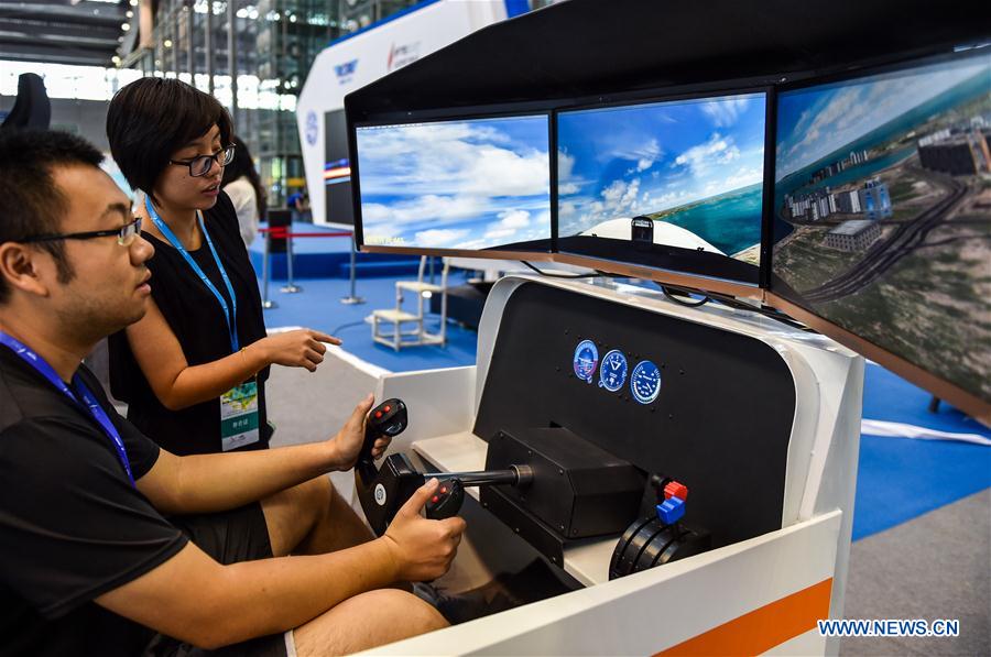 A visitor tries flight simulator at the 5th AOPA International Flight Training Exhibition in Shenzhen City of south China&apos;s Guangdong Province, Oct. 13, 2017. The 3-day exhibition kicked off here on Friday. (Xinhua/Mao Siqian) 