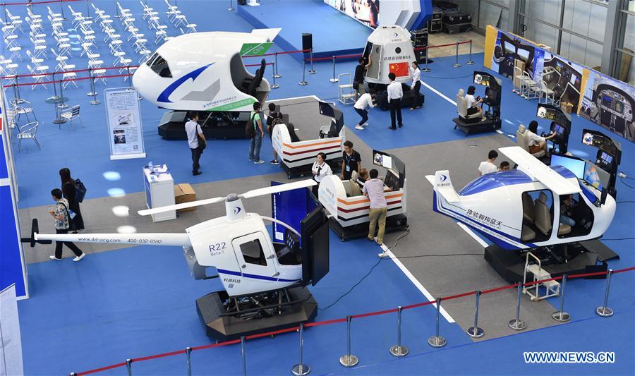 A visitor tries flight simulator at the 5th AOPA International Flight Training Exhibition in Shenzhen City of south China&apos;s Guangdong Province, Oct. 13, 2017. The 3-day exhibition kicked off here on Friday. (Xinhua/Mao Siqian)