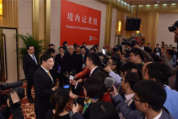 Miao Wei, minister of industry and information technology, is surrounded by reporters at a news conference on Thursday. [Feng Yongbin/China Daily] 