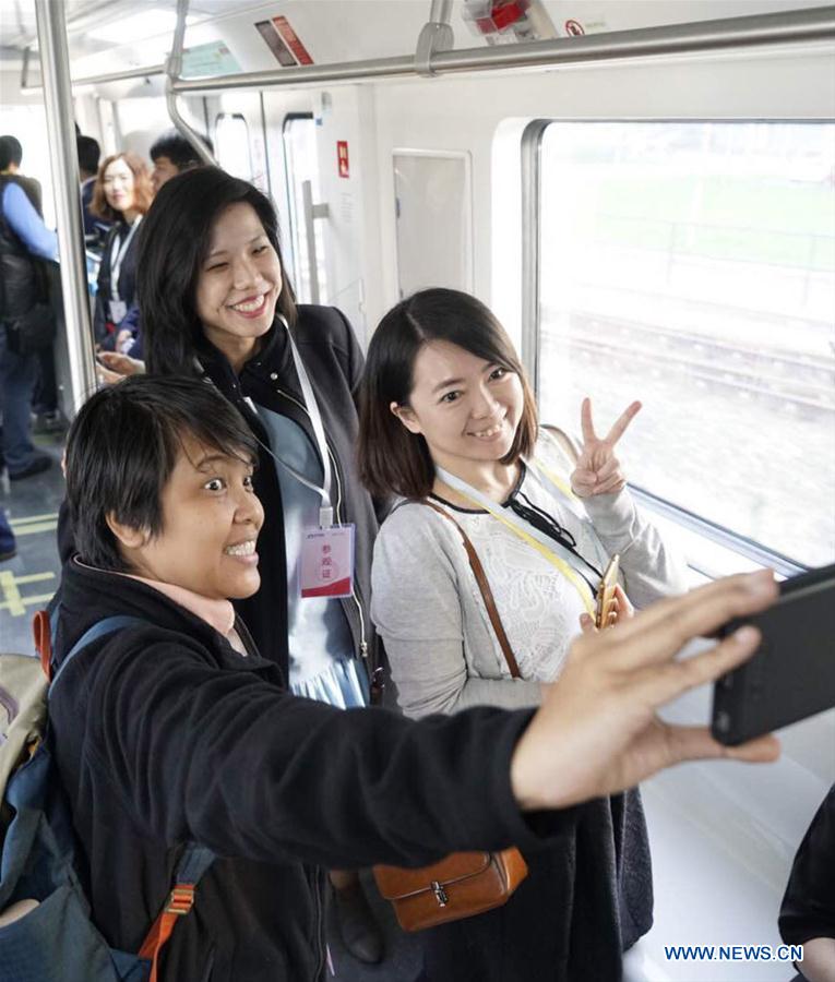 Journalists take a selfie as they visit the subway Yanfang line in Beijing, capital of China, Oct. 20, 2017. Chinese and foreign journalists visited the command center of Beijing's subway and subway Yanfang line in Beijing on Friday. [Photo/Xinhua]