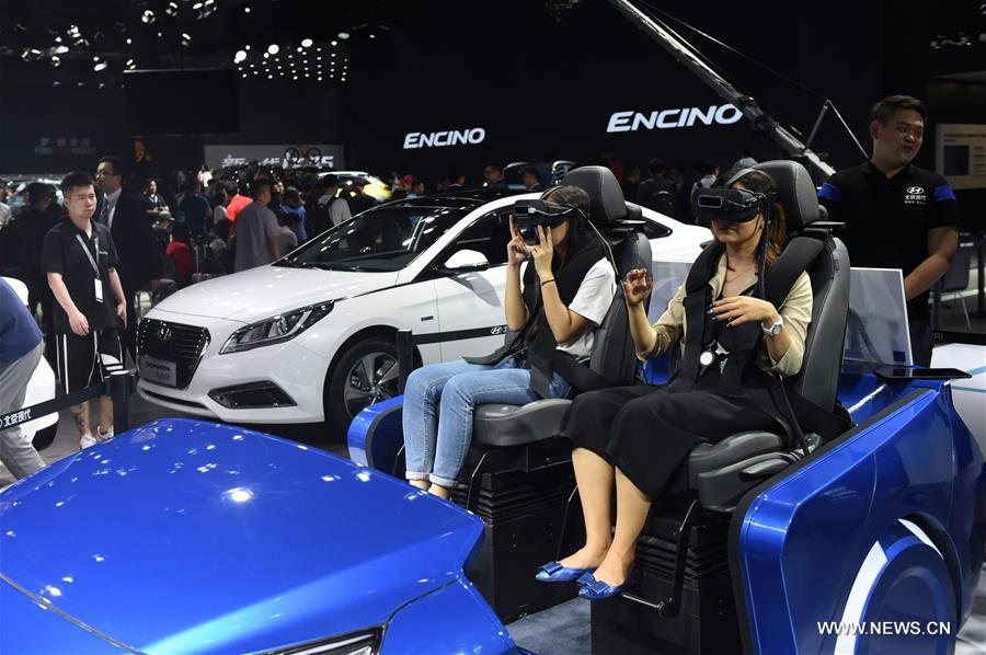 Visitors experience driving using virtual reality devices at the 15th Guangzhou International Automobile Exhibition in Guangzhou, capital of south China&apos;s Guangdong Province, Nov. 17, 2017. The exhibition started on Friday and attracted many international manufacturers of cars and parts. The event will last till Nov. 26. (Xinhua/Lu Hanxin) 