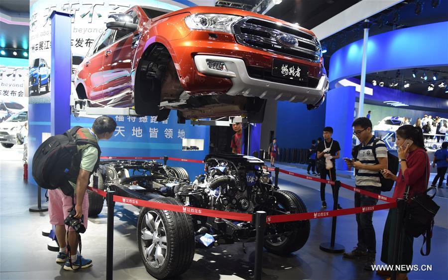 Visitors watch a car at the 15th Guangzhou International Automobile Exhibition in Guangzhou, capital of south China&apos;s Guangdong Province, Nov. 17, 2017. The exhibition started on Friday and attracted many international manufacturers of cars and parts. The event will last till Nov. 26. (Xinhua/Lu Hanxin) 