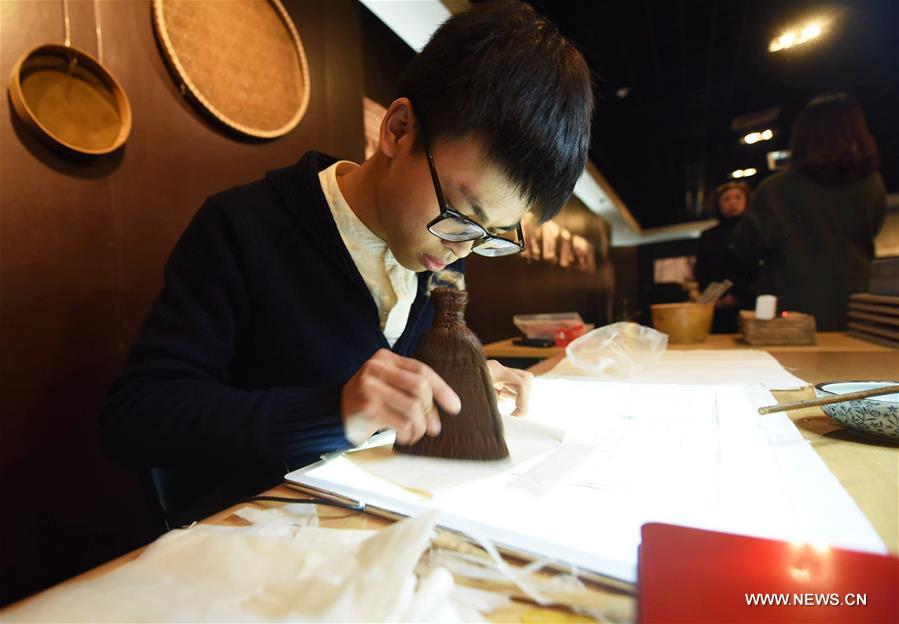Chen Zeliang, a restorer of ancient books, works on a genealogy record in Qing Dynasty (1644-1911) during a special exhibition at the Zhejiang Library in Hangzhou, capital of east China&apos;s Zhejiang Province, Nov. 16, 2017. The special exhibition on ancient book restoration will last till Nov. 23. (Xinhua/Long Wei)