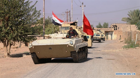 Military vehicles of Iraqi army carry out an operation to drive out Islamic State (IS) militants from their last urban stronghold in the Iraqi western border with Syria, near Rawa, Iraq, on Nov. 11, 2017. [Photo/Xinhua] 