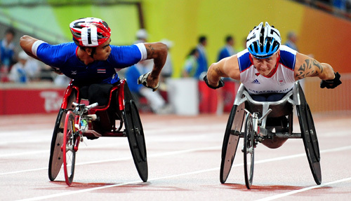 David Weir of Great Britain (R) wins the gold medal in the Men's 1500m T54. 