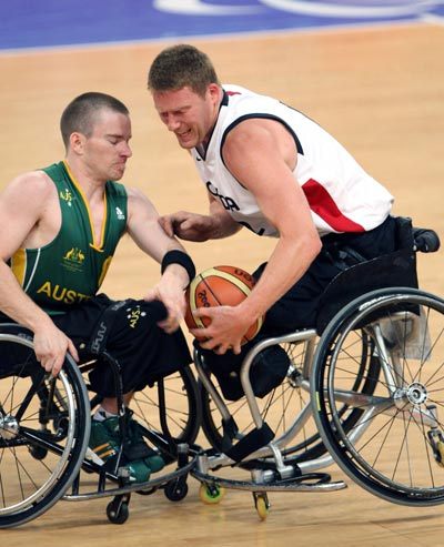 Patrick Anderson (R) of Canada vies the ball with player of Australia. 