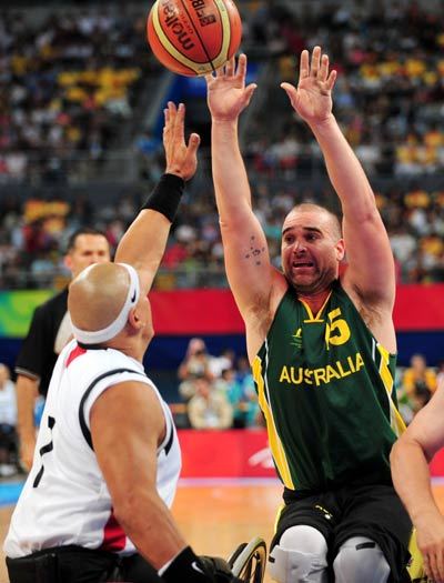 Brad Ness (R) of Australia guards as rivalry shoots.