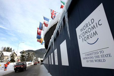 Flags and logo of the World Economic Forum (WEF) are seen at the conference center in Davos, Switzerland, on January 26, 2009. [Xinhua]