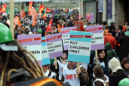 People hold placards during a demonstration in London on March 28, 2009. The Put People First group, an alliance of more than 150 unions, on Saturday organized the demonstration, calling on the leaders of the Group of 20 Countries (G20) to adopt sustainable policies that can lead the world out of recession. The demonstrators also urged the leaders to attach importance to global environment protection and to stablize the world political situation.