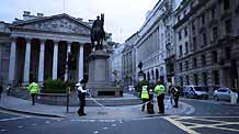 Police officers work in front of the building of the Royal Exchange in London on March 31, 2009. A suspected package was found near the building of the Royal Exchange on Tuesday. Police sealed off the area, but shortly afterwards an all clear order was given. London police have tightened security for the summit of the Group of 20 Countries to protect the meeting from possible violent protests.