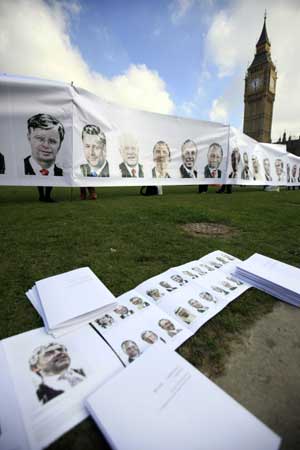 Portraits of leaders of the Group of 20 Countries are seen during a demonstration in London on April 1, 2009. Demonstrations held by environmentlists, anti-war and anti-capitalism activists broke out in many places in London on April 1, one day before the Group of 20 Countries summit, kindling fierce violence in the financial hub, City of London.