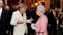 British Queen Elizabeth II (R Front) talks with German Chancellor Angela Merkel during a reception hosted by the queen for leaders of the Group of 20 Countries (G20) at Buckingham Palace in London on April 1, 2009. The G20 Summit on Financial Markets and World Economy will be held in London on April 2.