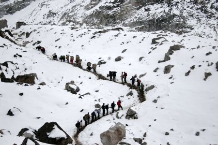 The photo taken on May 28, 2009 shows Trekkers walk at the Qomolangma Base Camp in Solokhumbu district northeast of Kathmandu, capital of Nepal. (Xinhua/Bimal Gautam)