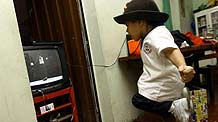 Jose Manuel Sanchez Aguero, a five-year-old boy, imitates Michael Jackson at home in Barquisimeto, Venezuela, October 30, 2009.