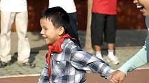 Assisted by a volunteer, Chen Yu (L), a 7-year-old blind boy, runs in the 100 meter competiton at a sports games in the Nanchang Blind Children's School in Nanchang, capital city of east China's Jiangxi Province, on October 30, 2009.