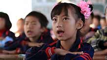 Wang Jinlian attends class at Minzu Elementary School in Rongshui Miao Autonomous County, southwest China's Guangxi Zhuang Autonomous Region, November 6, 2009.