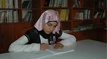 Photo taken on October 29, 2009 shows Sahar Karmo (1st R) reading a book in a library.Every afternoon, the 12-year-old Sahar Karmo goes to the Youth and Children Center in Beirut's Shatila Palestinian Refugee Camp for free education.