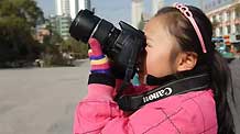 Zhang Jiaqi practises taking photos in downtown Xining on October 31, 2009. Zhang Jiaqi, ten-year-old, a firth-grade pupil of the Jiaxiaozhuang Primary School in Xining, northwest China's Qinghai Province.