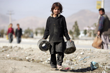 Asma takes care of their roadside workshop after her brothers go to school in Kabul, capital of Afghanistan, on October 31, 2009. 