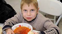 Eight-year-old Sacha has his lunch at the dining hall of Voenno-antonovskiy Orphan School in Bishkek, capital of Kyrgyzstan, November 19, 2009.