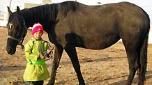 The picture I took on October 27, 2009 shows my friend is ready to ride on a horse in Ulan Bator, Mongolia.