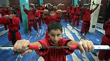Palestinian children practise Kungfu during martial arts training class at the Red Dragon School in Beit Lahiyathe Town, northern Gaza, Palestine, November 21, 2009. Over 10 clubs like Red Dragon Scholl teach martial arts in Gaza. Each of them has more than 150 members.