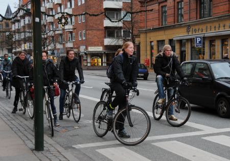 People ride bicycles on a bicycle path in Copenhagen, capital of Denmark, on November 23, 2009. Copenhagen is known as one of the most bicycle-friendly cities in the world.
