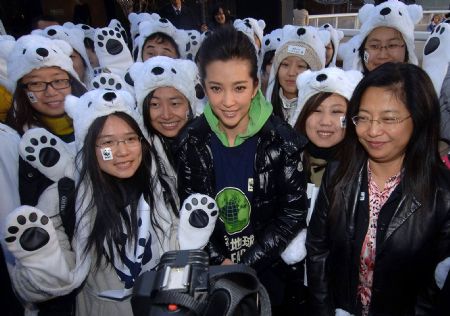 Li Bingbing (C, front), an ambassador of Earth Hour campaign in China, poses for a photo with volunteers dress in the polar bear costumes during an activity held by the World Wide Fund for Nature (WWF) to welcome the UN climate change conference in Copenhagen, in Beijing, capital of China, December 2, 2009